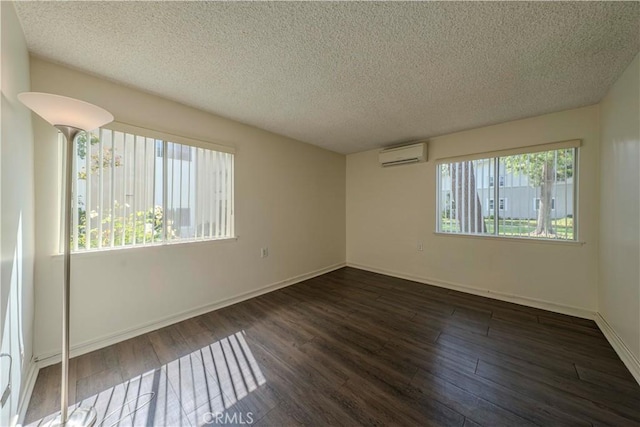 368 Avenida Castilla Unit B, Laguna Woods, CA 92637 - spare room featuring a wall mounted air conditioner, dark wood-style flooring, and a textured ceiling