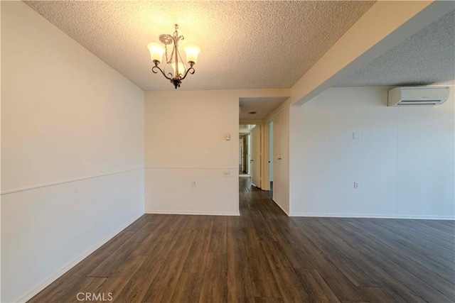 368 Avenida Castilla Unit B, Laguna Woods, CA 92637 - unfurnished room featuring a textured ceiling, a wall unit AC, a chandelier, and dark wood-style floors