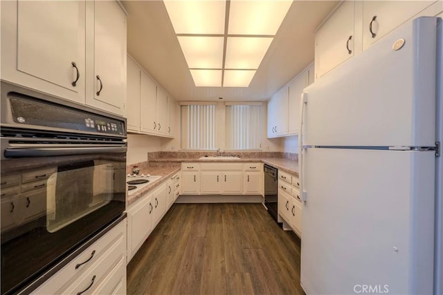 368 Avenida Castilla Unit B, Laguna Woods, CA 92637 - kitchen with black appliances, white cabinetry, dark wood-style flooring, and light countertops