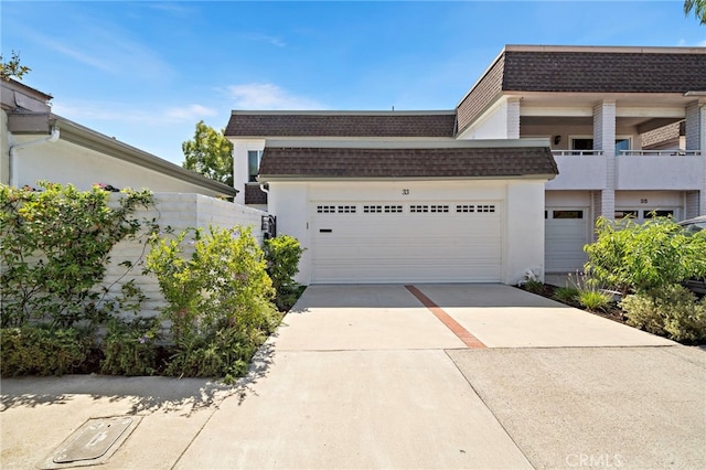 33 Seton Rd, Irvine, CA 92612 - view of front of home featuring roof with shingles, mansard roof, concrete driveway, a garage, and stucco siding