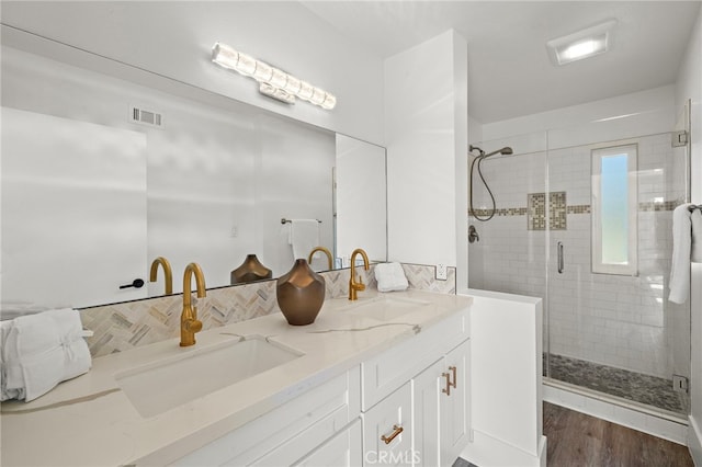 33 Seton Rd, Irvine, CA 92612 - full bathroom with double vanity, backsplash, a shower stall, and wood finished floors