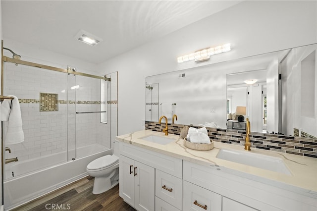 33 Seton Rd, Irvine, CA 92612 - full bathroom featuring wood finished floors, double vanity, shower / bath combination with glass door, and decorative backsplash