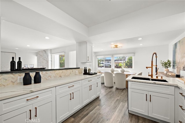 33 Seton Rd, Irvine, CA 92612 - kitchen featuring recessed lighting, decorative backsplash, white cabinetry, wood finished floors, and a peninsula