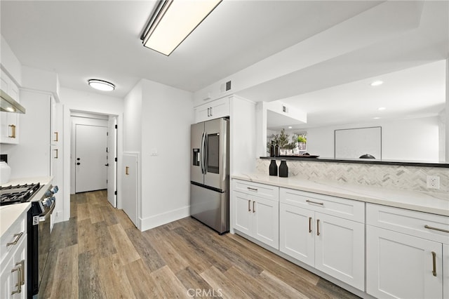 33 Seton Rd, Irvine, CA 92612 - kitchen featuring stainless steel refrigerator with ice dispenser, gas stove, light wood finished floors, tasteful backsplash, and white cabinets