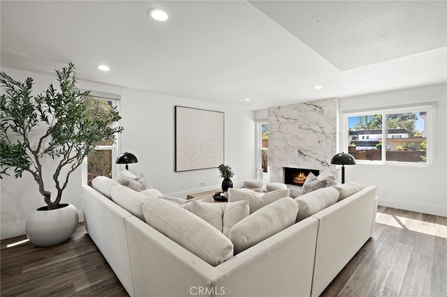 33 Seton Rd, Irvine, CA 92612 - living area with healthy amount of natural light, a high end fireplace, dark wood-type flooring, and recessed lighting