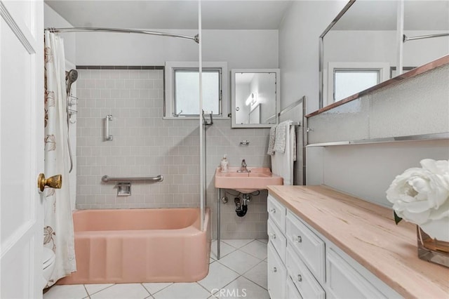 9700 Nita Ave, Chatsworth, CA 91311 - bathroom featuring tile patterned flooring, shower / tub combo with curtain, and tile walls