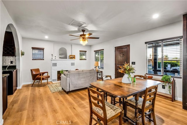 68613 E St, Cathedral City, CA 92234 - dining area with a ceiling fan, light wood-style flooring, recessed lighting, and a fireplace