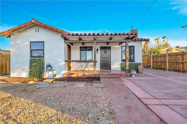 68613 E St, Cathedral City, CA 92234 - mediterranean / spanish home featuring a tile roof, a porch, and stucco siding