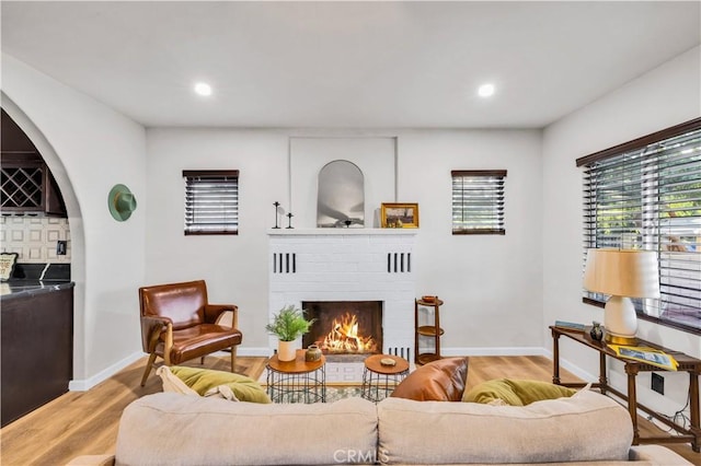 68613 E St, Cathedral City, CA 92234 - living area featuring light wood-style flooring, a brick fireplace, and recessed lighting