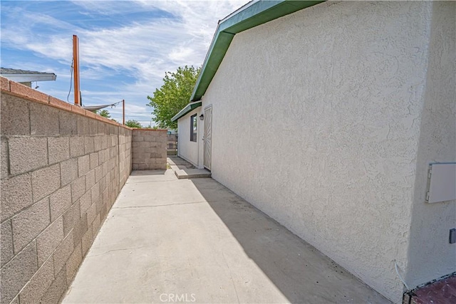 44623 Gingham Ave, Lancaster, CA 93535 - view of home's exterior featuring stucco siding, a fenced backyard, and a patio area