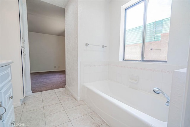 44623 Gingham Ave, Lancaster, CA 93535 - bathroom with vanity, a garden tub, healthy amount of natural light, and tile patterned floors