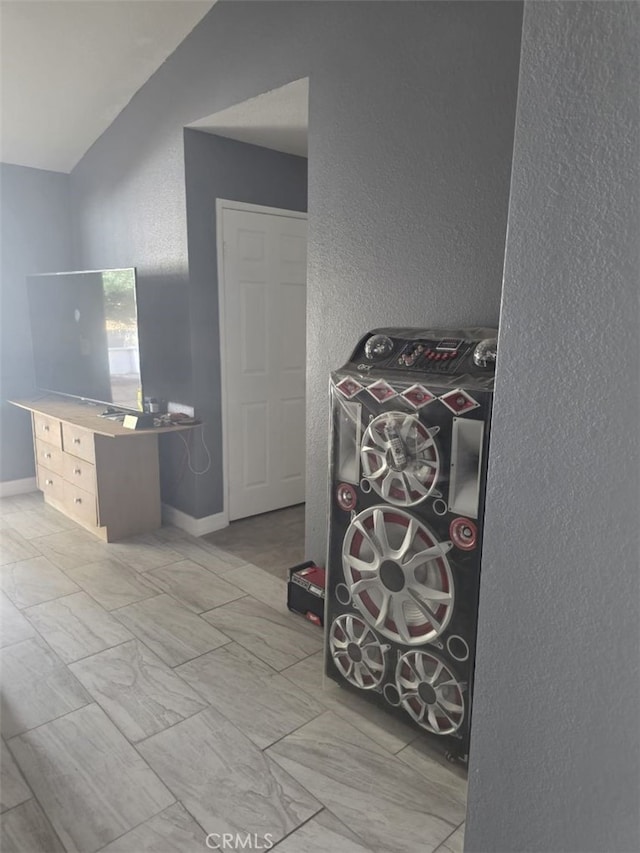 15171 San Jose Dr, Victorville, CA 92394 - game room featuring a textured wall, lofted ceiling, and marble finish floors