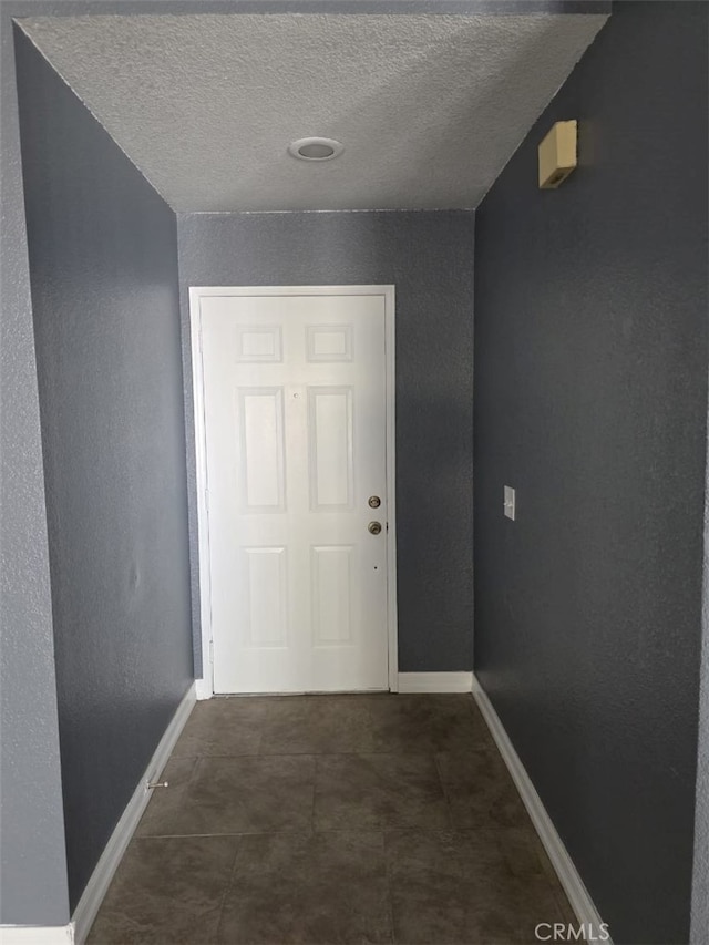 15171 San Jose Dr, Victorville, CA 92394 - hallway featuring a textured ceiling and baseboards