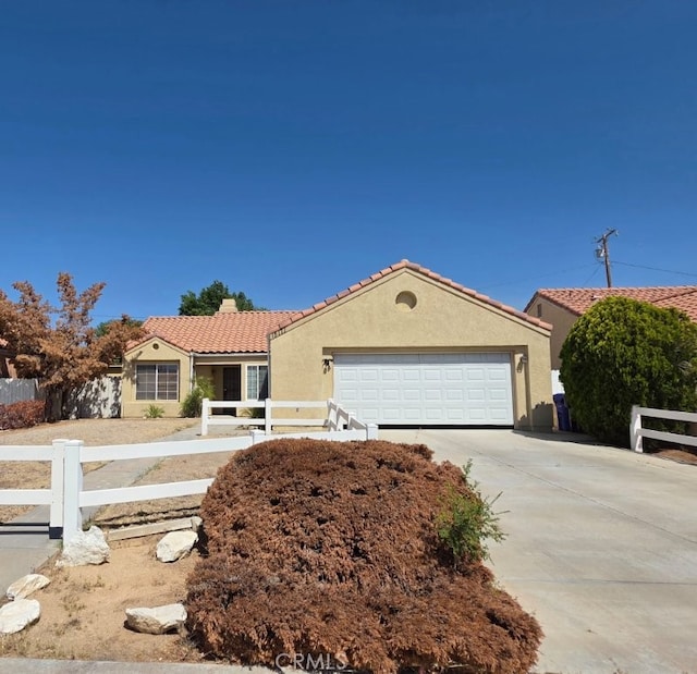 15171 San Jose Dr, Victorville, CA 92394 - ranch-style house with a fenced front yard, stucco siding, a tiled roof, concrete driveway, and a garage
