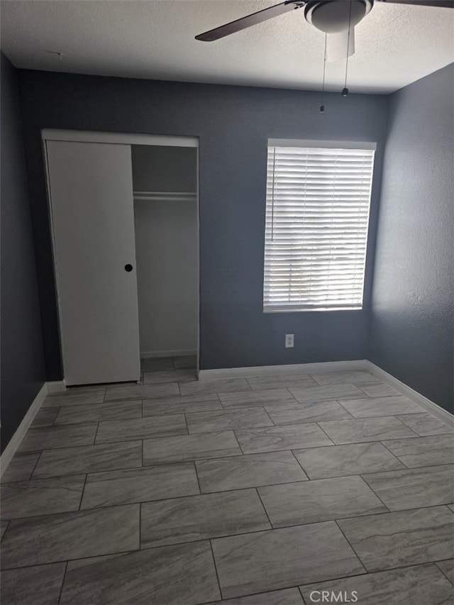 15171 San Jose Dr, Victorville, CA 92394 - unfurnished bedroom with a closet, a ceiling fan, and a textured ceiling