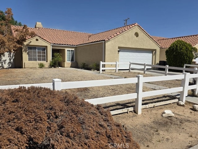 15171 San Jose Dr, Victorville, CA 92394 - ranch-style home with a garage, a fenced front yard, a tile roof, and stucco siding