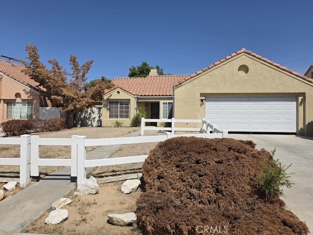 15171 San Jose Dr, Victorville, CA 92394 - view of front of home featuring a fenced front yard, concrete driveway, an attached garage, and stucco siding