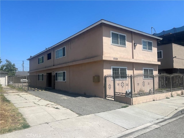 10124 S Inglewood Ave, Inglewood, CA 90304 - view of front of property with stucco siding, a fenced front yard, and a gate
