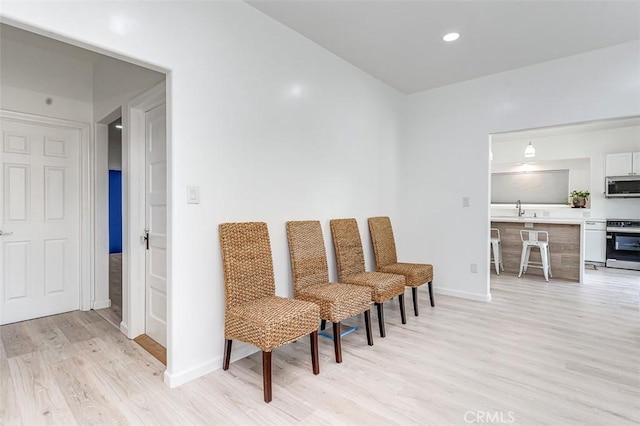 715 S Norton Ave, Los Angeles, CA 90005 - living area featuring light wood finished floors and recessed lighting