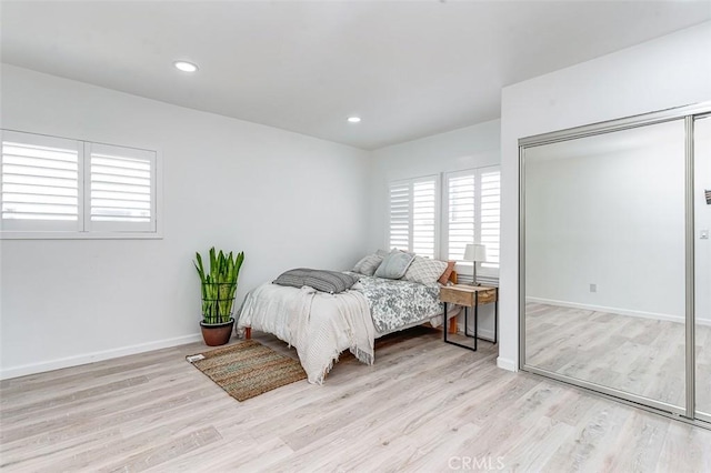 715 S Norton Ave, Los Angeles, CA 90005 - bedroom with multiple windows, light wood-style flooring, and recessed lighting