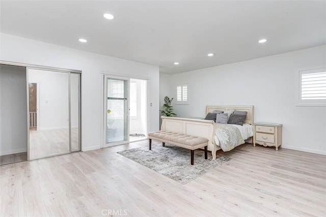 715 S Norton Ave, Los Angeles, CA 90005 - bedroom with wood finished floors, multiple windows, recessed lighting, and access to outside