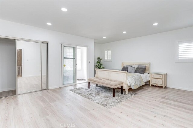715 S Norton Ave, Los Angeles, CA 90005 - bedroom with wood finished floors, multiple windows, recessed lighting, and access to outside