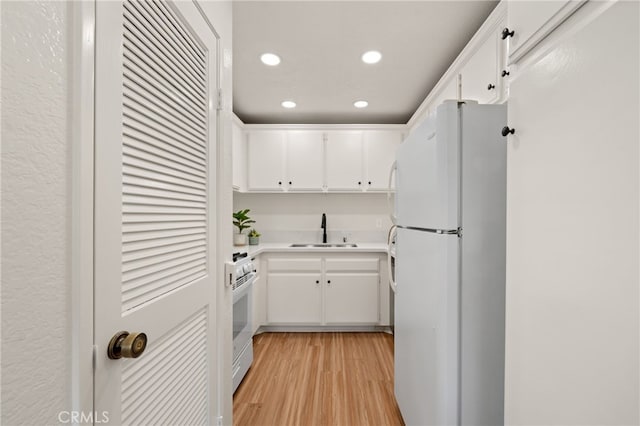 22832 Hilton Head Dr Unit 98, Diamond Bar, CA 91765 - kitchen featuring white appliances, recessed lighting, light wood-style floors, white cabinetry, and light countertops