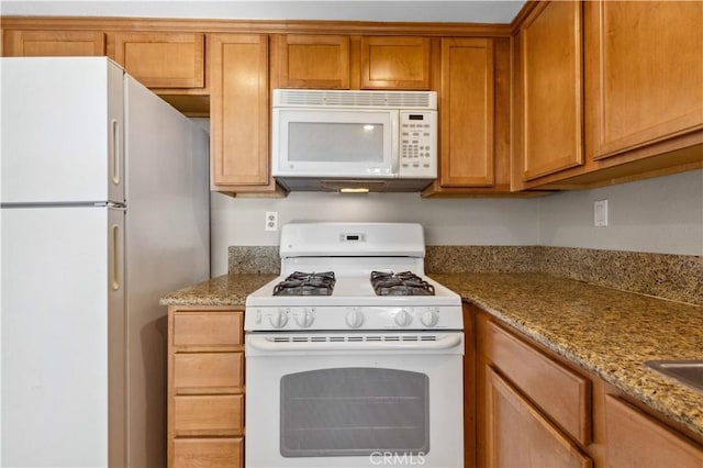 1339 Massachusetts Ave Unit 101, Riverside, CA 92507 - kitchen featuring white appliances, brown cabinets, and light stone counters