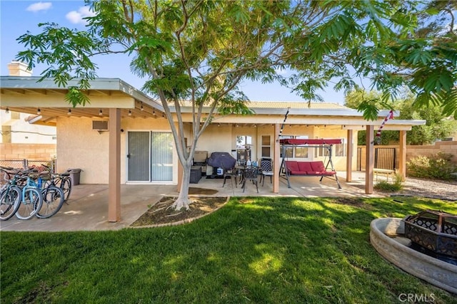 2908 Owens Way, Rosamond, CA 93560 - rear view of property featuring an outdoor fire pit, a patio, and stucco siding