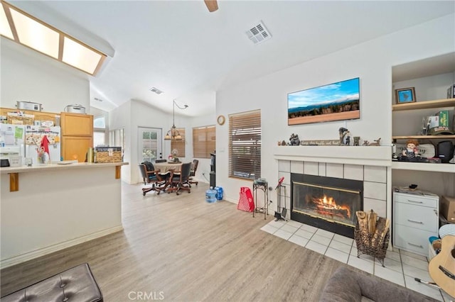 2908 Owens Way, Rosamond, CA 93560 - living area with vaulted ceiling, a tile fireplace, and wood finished floors