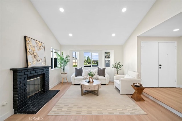 15604 Sharonhill Dr, Whittier, CA 90604 - living area featuring lofted ceiling, a fireplace, wood finished floors, and recessed lighting