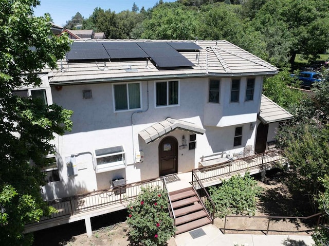 34667 Navajo Rd, Julian, CA 92036 - view of front facade with stucco siding, roof mounted solar panels, and a deck