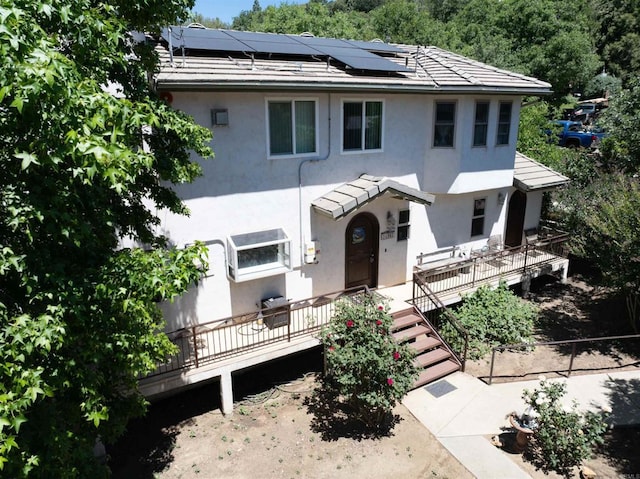 34667 Navajo Rd, Julian, CA 92036 - view of front of house featuring stucco siding, roof mounted solar panels, a tiled roof, and a deck