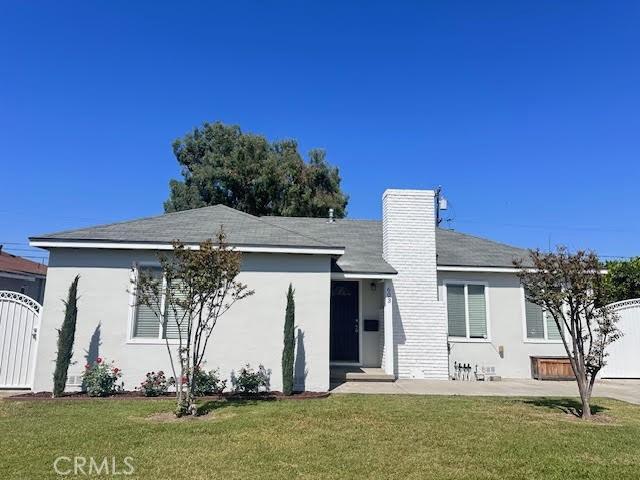 603 N Hawthorn St, Anaheim, CA 92805 - view of front of property featuring stucco siding, a gate, and a chimney
