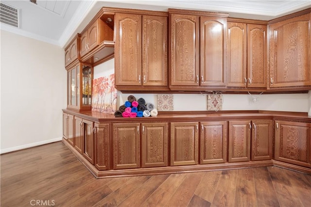 26677 Avenida Del Oro, Temecula, CA 92590 - kitchen featuring dark wood-type flooring, crown molding, and brown cabinetry