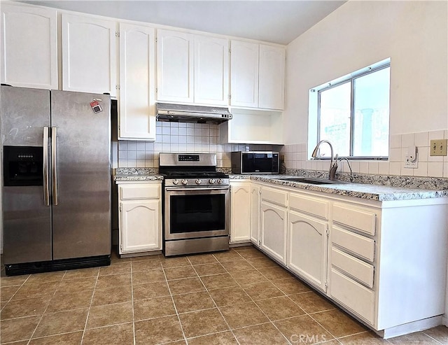 3033 N Main St, Los Angeles, CA 90031 - kitchen with stainless steel appliances, under cabinet range hood, backsplash, and white cabinets