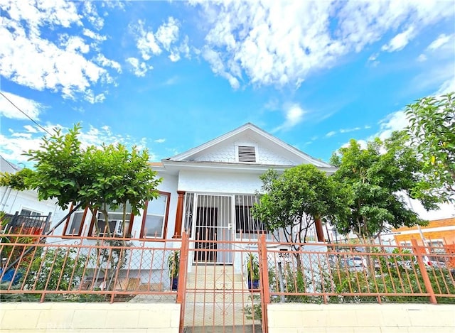 3033 N Main St, Los Angeles, CA 90031 - view of front of house with a fenced front yard, a gate, and stucco siding