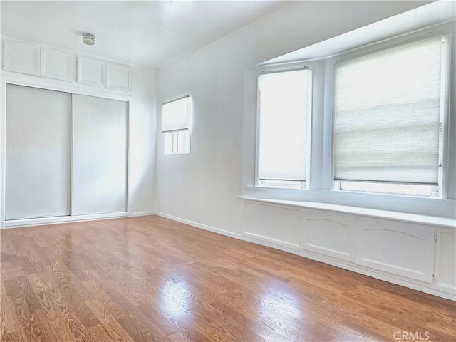 3033 N Main St, Los Angeles, CA 90031 - unfurnished bedroom featuring light wood finished floors and a closet
