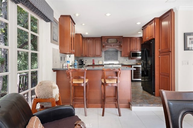 1924 E Rancho Culebra Dr, Covina, CA 91724 - kitchen with stainless steel microwave, black refrigerator with ice dispenser, a peninsula, range, and beverage cooler