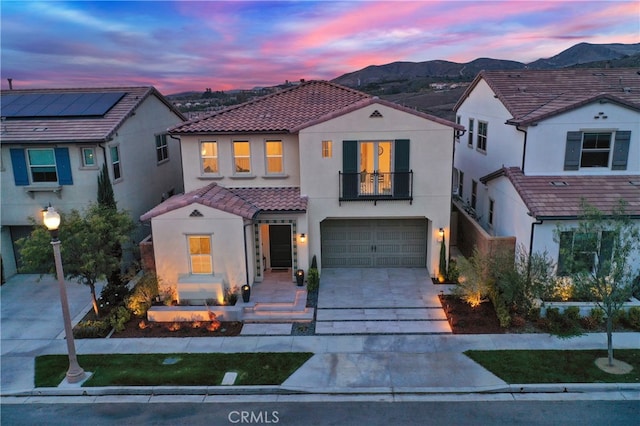 109 Ritual, Irvine, CA 92618 - view of front of house featuring a tiled roof, stucco siding, a mountain view, a balcony, and driveway