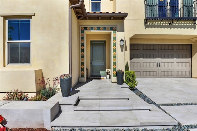 109 Ritual, Irvine, CA 92618 - entrance to property with stucco siding, an attached garage, and driveway