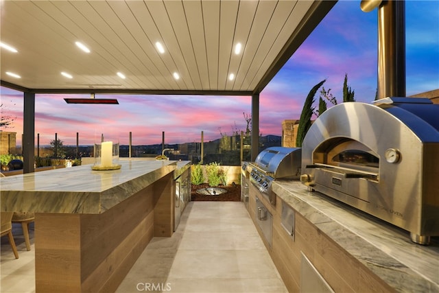 109 Ritual, Irvine, CA 92618 - patio terrace at dusk with an outdoor kitchen