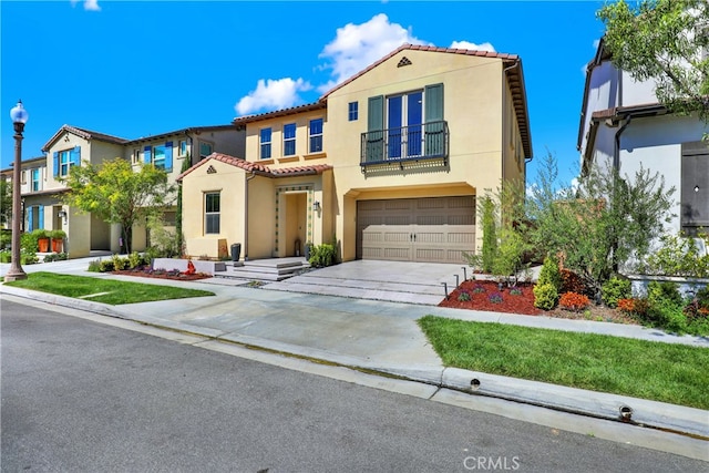 109 Ritual, Irvine, CA 92618 - mediterranean / spanish home featuring a balcony, stucco siding, a tiled roof, a garage, and driveway