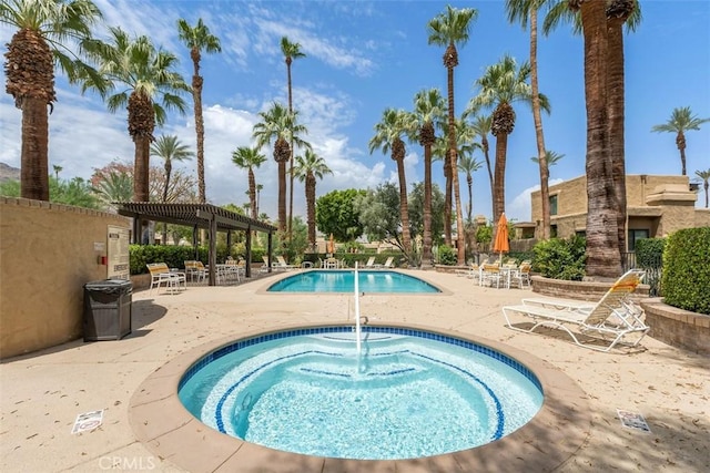 4881 S Winners Cir Unit A, Palm Springs, CA 92264 - community pool with a hot tub, a patio area, and a pergola