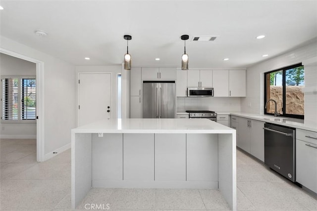 4881 S Winners Cir Unit A, Palm Springs, CA 92264 - kitchen with stainless steel appliances, recessed lighting, hanging light fixtures, light countertops, and tasteful backsplash