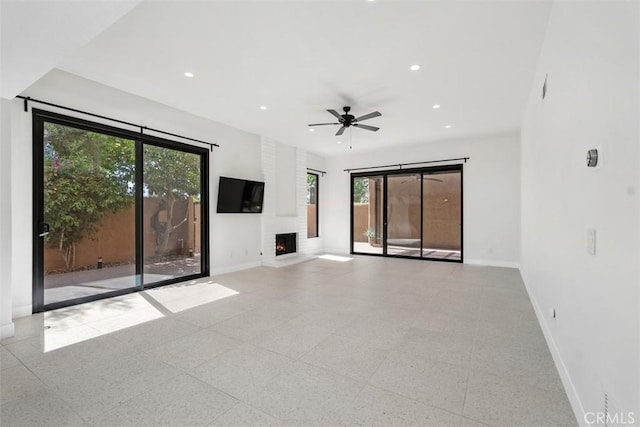 4881 S Winners Cir Unit A, Palm Springs, CA 92264 - unfurnished living room featuring a fireplace, ceiling fan, and recessed lighting