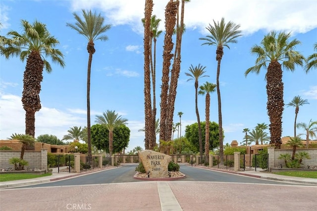 4881 S Winners Cir Unit A, Palm Springs, CA 92264 - view of road featuring sidewalks, curbs, and a gated entry