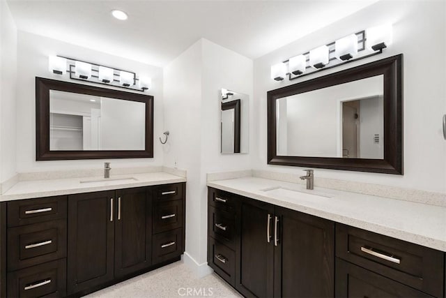 4881 S Winners Cir Unit A, Palm Springs, CA 92264 - bathroom featuring two vanities, speckle patterned floor, and recessed lighting