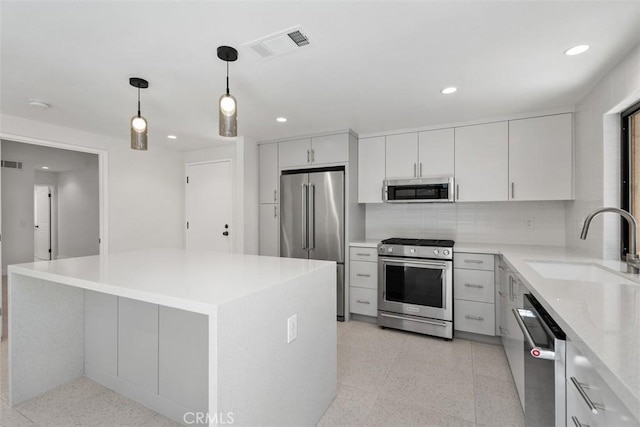 4881 S Winners Cir Unit A, Palm Springs, CA 92264 - kitchen with stainless steel appliances, recessed lighting, pendant lighting, backsplash, and a kitchen island