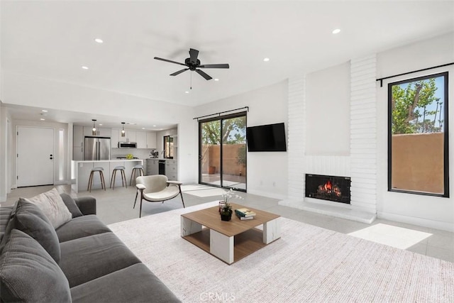 4881 S Winners Cir Unit A, Palm Springs, CA 92264 - living area with recessed lighting, a brick fireplace, and ceiling fan